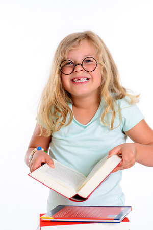 sweet funny girl with pile of books and round glassesの写真素材