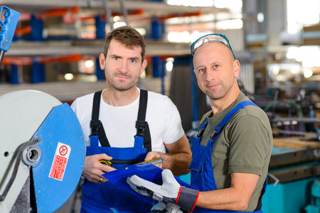 two worker in factory on the machineの写真素材