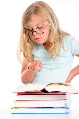 sweet funny girl with pile of books and round glassesの写真素材