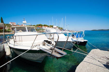 white boats in port in front of blue skyの写真素材