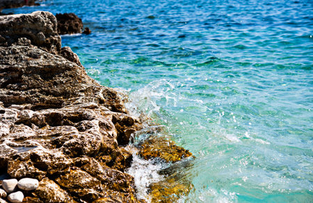 Rocky coast with splash  water in front of blue sea - Croatiaの写真素材