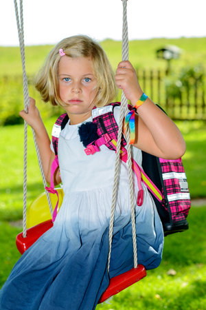 blond girl with schoolbag on first day at schoolの写真素材