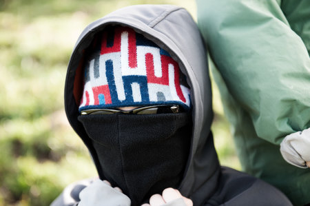 masket person with sunglasses and hoodの写真素材