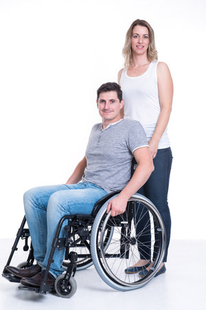 Young disabled man in wheelchair and his wifeの写真素材