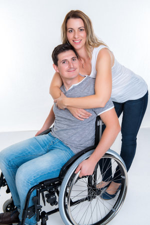 Young disabled man in wheelchair and his wifeの写真素材
