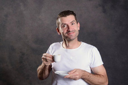 young dark haired man drinking espressoの写真素材