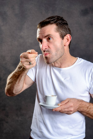 young dark haired man drinking espressoの写真素材