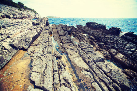 rocky coast in front of blue sea - Croatiaの写真素材