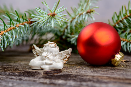 Christmas sill with angel, fir branch and x-mas ball on wooden groundの写真素材