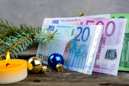 Christmas sill with money, fir branch and candleの写真素材
