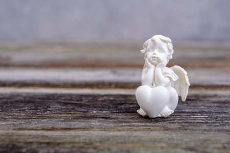 Sill life with angel on wooden groundの写真素材