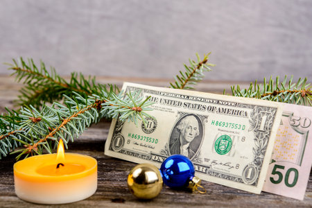 christmas sill with money, fir branch and candleの写真素材