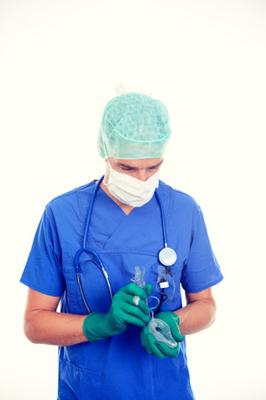 young anesthetist with larynx mask in front of white backgroundの写真素材