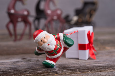 little Santa Claus pulling white gift boxの写真素材