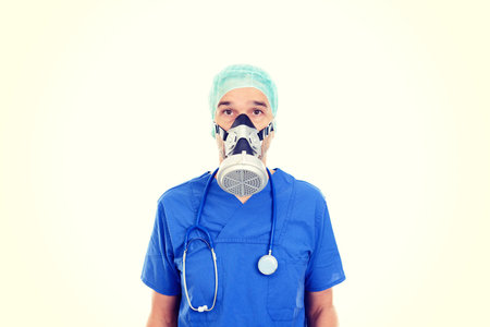 young doctor with gas mask in front of white backgroundの写真素材