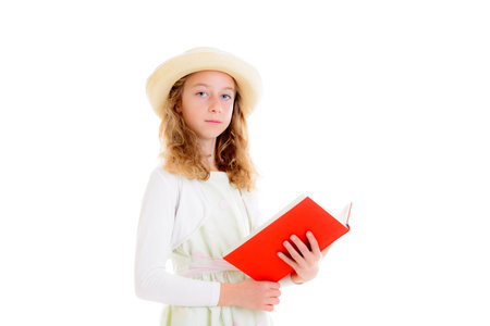 nice girl with blond hair in white dress and straw hat reading red bookの写真素材