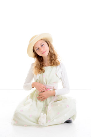 nice girl with blond hair in white dress and straw hat and little rabbitの写真素材