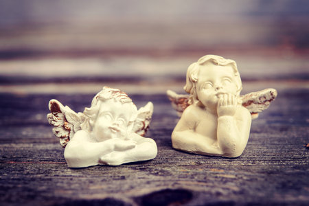 sill life with two angels on wooden groundの写真素材