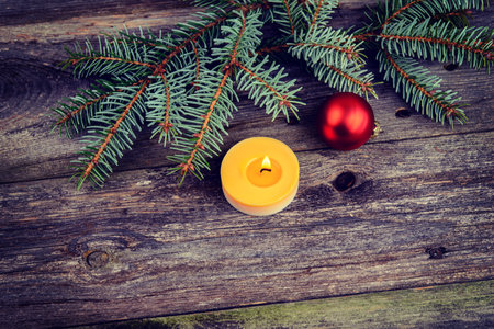 christmas sill with fir branch and candle on wooden groundの写真素材