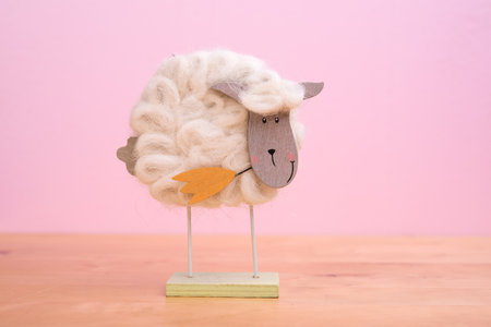 funny sheep with flower in front of pink backgroundの写真素材