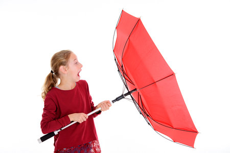  blond girl with red umbrella in frontof white backgroundの写真素材
