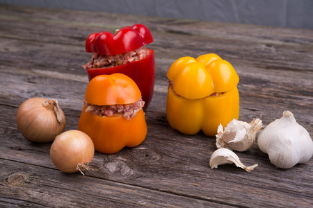colorful filled pepper,garlic and onion on wooden groundの写真素材