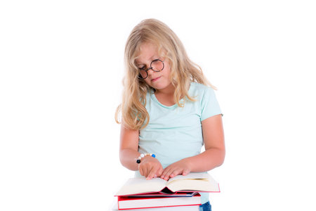 sweet funny girl with pile of books and round glassesの写真素材