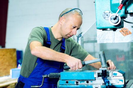 one worker in factory on the machineの写真素材