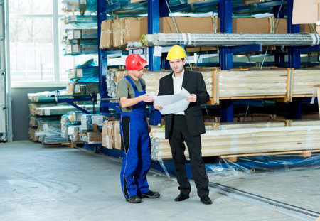 in the factory- young boss and worker in conversationの写真素材