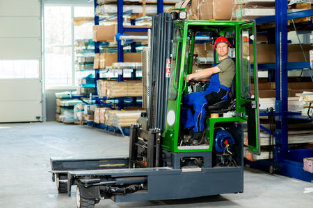 one worker in factory in lift truck looking in to the cameraの写真素材
