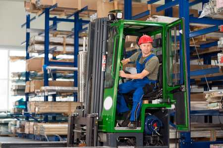 one worker in factory in lift truck looking in to the cameraの写真素材