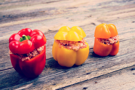 colorful filled pepper on wooden ground in vintage lookの写真素材