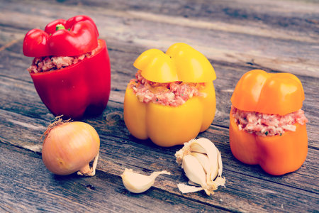 colorful filled pepper,garlic and onion on wooden groundの写真素材