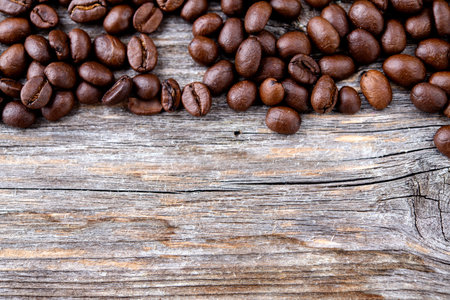  brown roasted coffee beans on wooden groundの写真素材