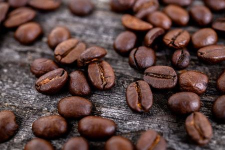 brown roasted coffee beans on wooden groundの写真素材