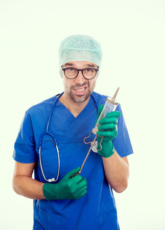 funny doctorwith big injection in front of white backgroundの写真素材