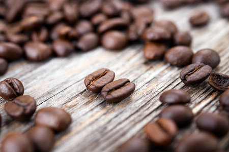 a lot of brown roasted coffee beans on wooden groundの写真素材