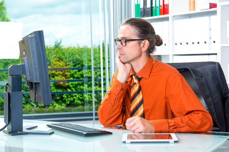 young business man at his desk workingの写真素材