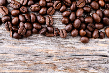  brown roasted coffee beans on wooden groundの写真素材