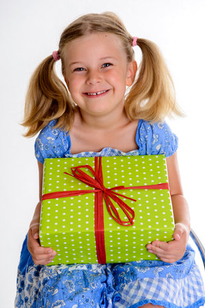 blond girl with green gift box in front of white backgroundの写真素材