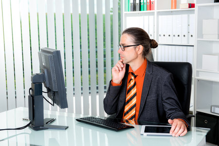 young business man at his desk workingの写真素材