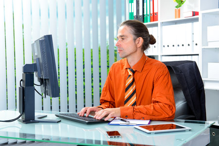 young business man at his desk workingの写真素材