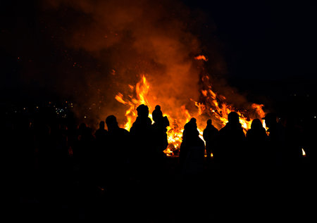 silhouettes of people in frontof big easter fireの写真素材