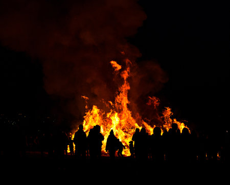 Silhouettes of people in front of big easter fireの写真素材