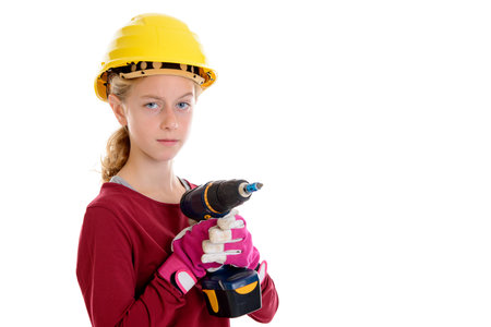 blond girl with helmet,cordless screwdriver and work gloves in front of white backgroundの写真素材