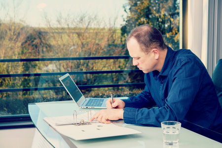young business man at his desk workingの写真素材