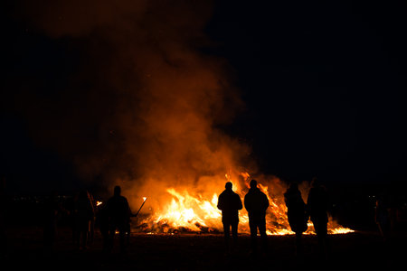 silhouettes of people in frontof big easter fireの写真素材