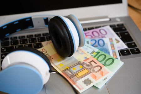 computer keyboard with headphones and euro bank notesの写真素材