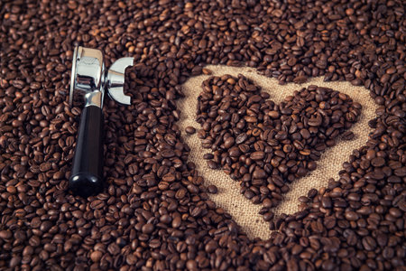 heart in a lot of coffee beans with heart with portafilterの写真素材