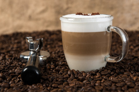 Latte Macchiato with heart on coffee beansの写真素材